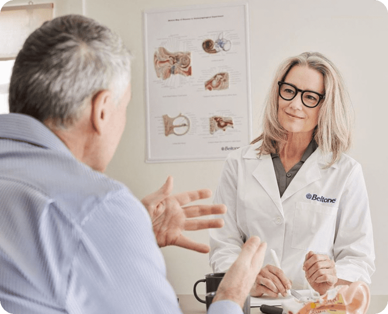 A patient and and professional discussing hearing aids
